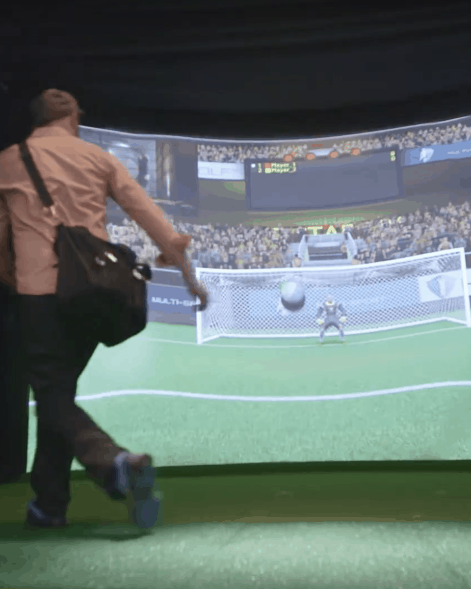 man playing soccer on simulator