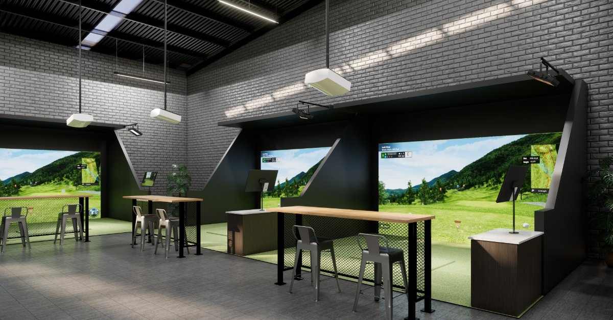 An indoor mini golf simulator room with projection screens, tall tables, chairs, brick walls, and green mats.